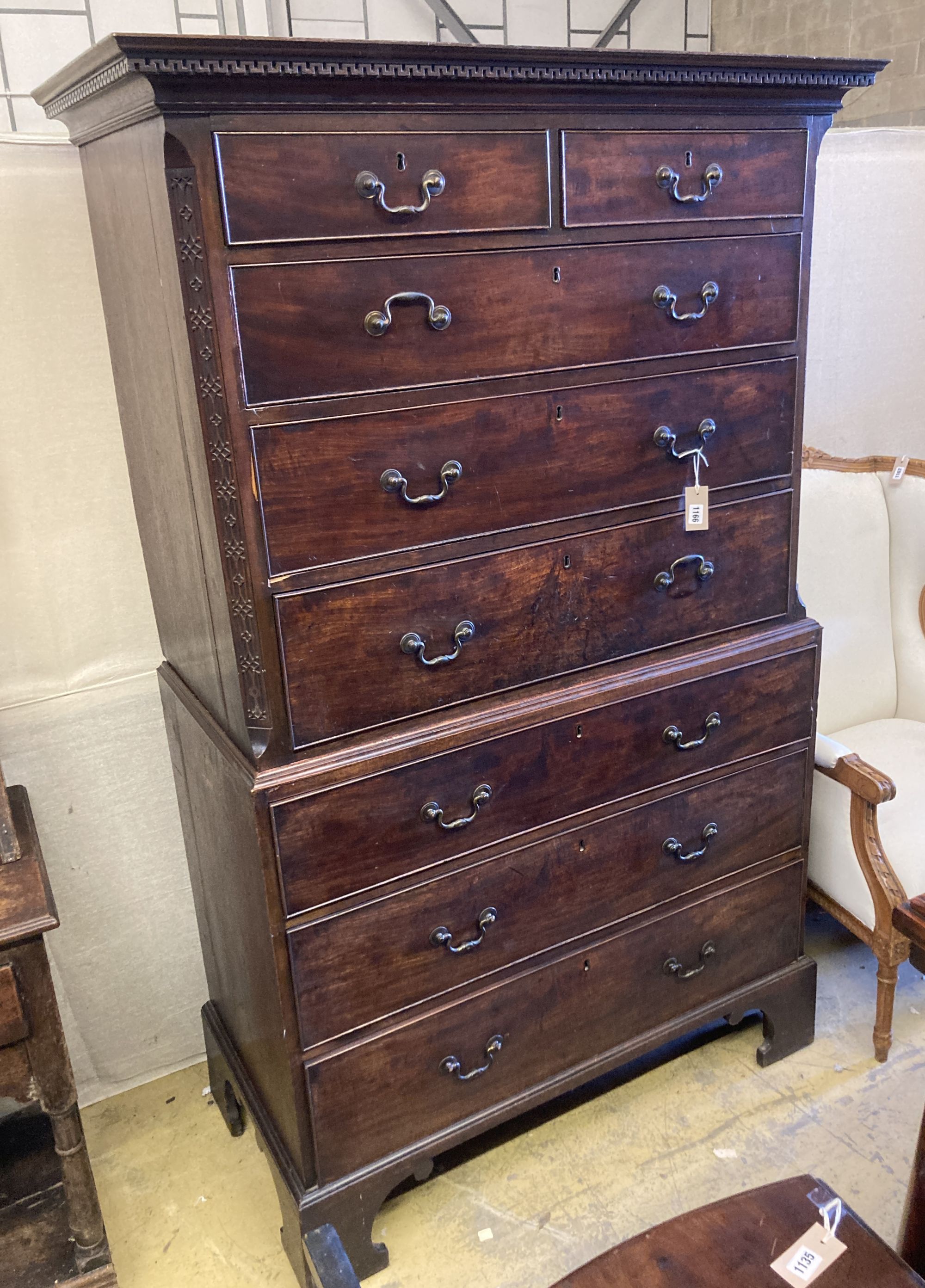 A George III mahogany chest on chest, two short and three long graduated drawers, the base with three graduated cockbeaded drawers, on